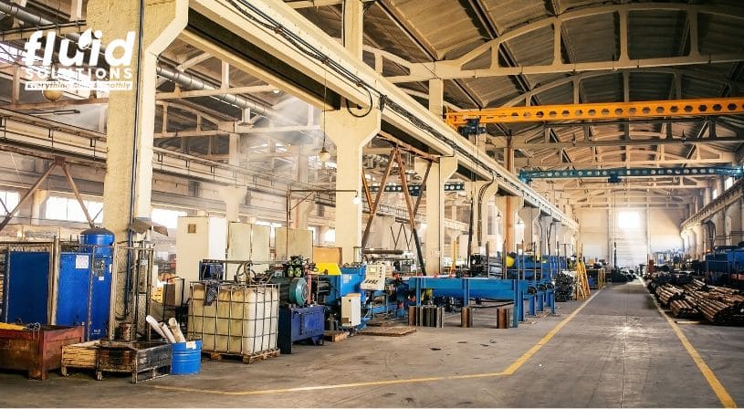 Spacious factory interior with various industrial equipment.