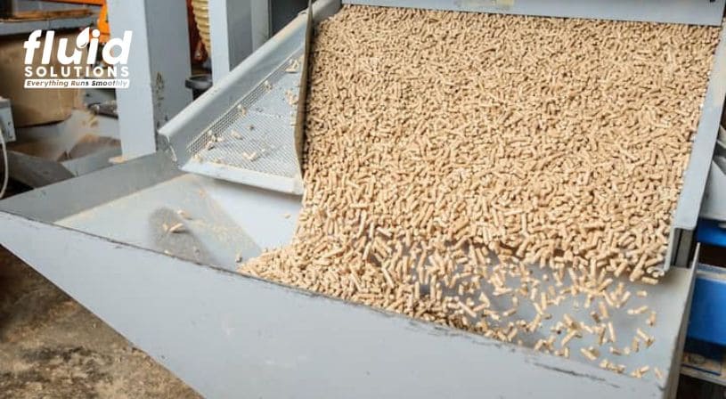 Pellet feed coming off a conveyor in a feed mill.