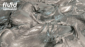 Thick, gray lubricant spread out in a textured surface.