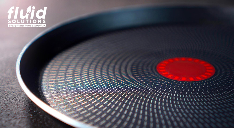 Bottom of a non-stick pan with a heat indicator.