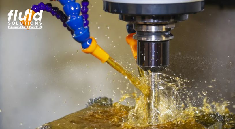 CNC machine applying coolant during cutting process.