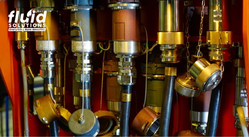 Close-up view of hydraulic pumps and hoses in an industrial machine.