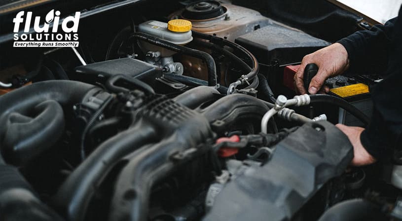 Mechanic working on a car engine.