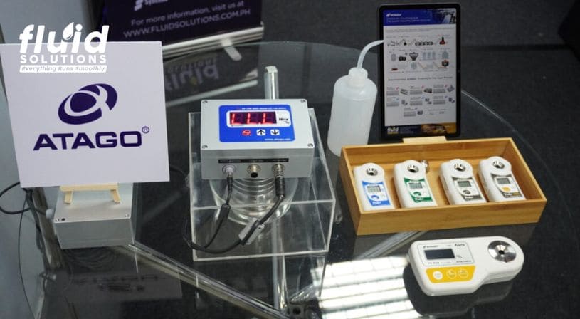 Display of Fluid Solutions instruments and product samples at a trade show.