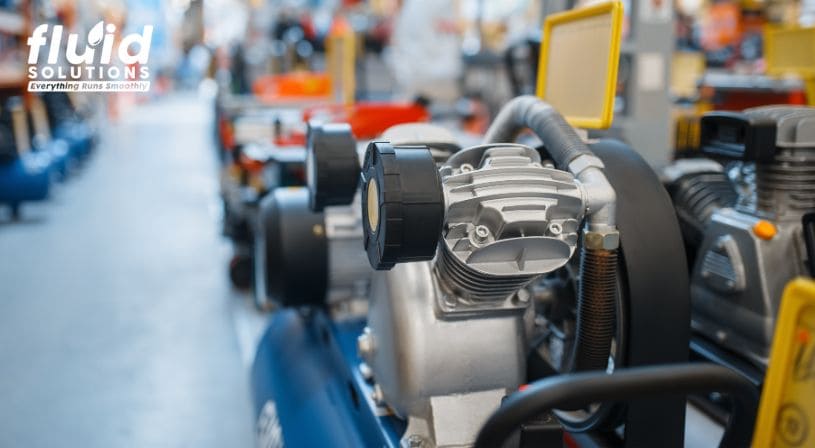 Close-up of an air compressor in a factory setting.