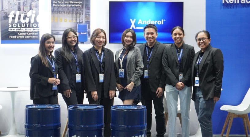 Group photo of Fluid Solutions team at a trade show booth