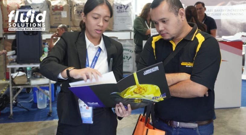 Fluid Solutions representative explaining products to a trade show attendee.