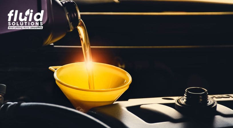 Engine oil being poured into a funnel during vehicle maintenance