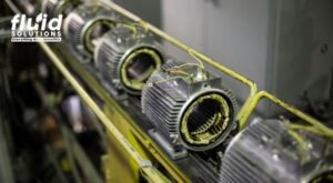 Electric motors lined up in a production facility, showcasing industrial manufacturing