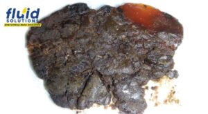 Hardened degraded lubricant residue.