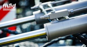 Close-up of hydraulic cylinders in machinery.
