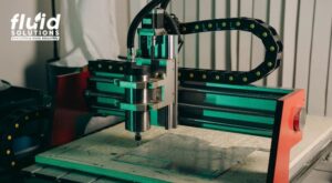 CNC machine under operation in workshop.