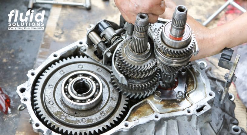 Technician working on disassembled gear transmission
