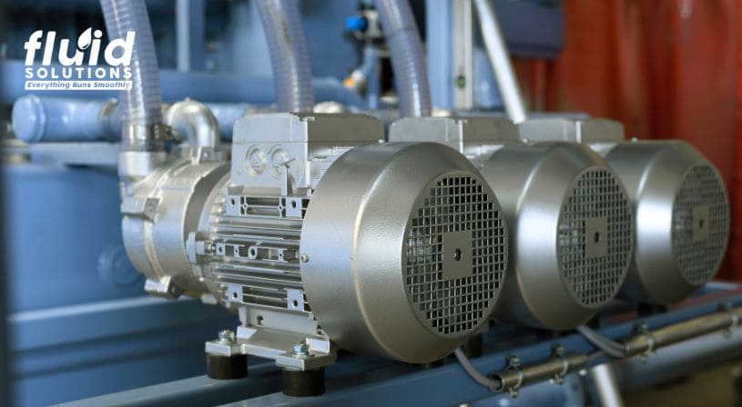 Close-up of industrial electric motors in a fluid system.