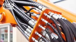 Hydraulic hoses delivering fluid for heavy equipment lubrication and control systems