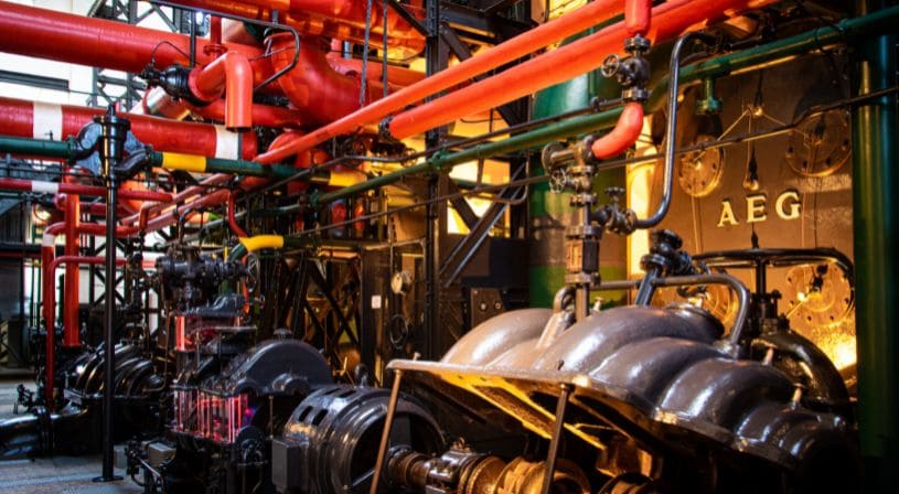 Industrial machinery with red and black pipes in a factory.
