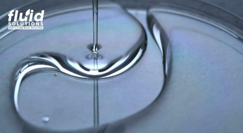 Thick industrial fluid or lubricant pouring smoothly, demonstrating viscosity and flow characteristics