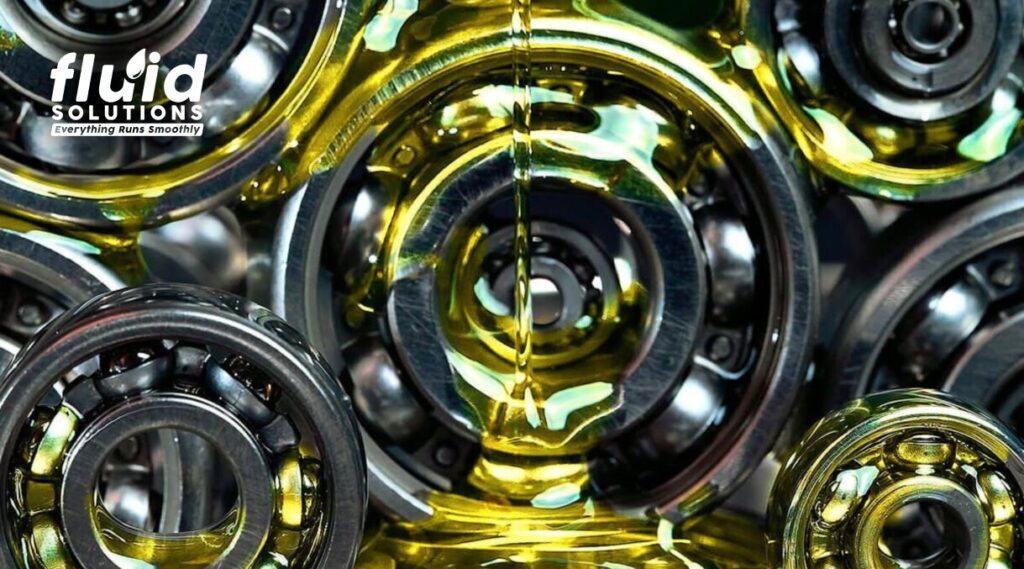 High-performance gear and bearing lubrication oil flowing over industrial ball bearings for smooth machine operation.