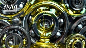 High-performance gear and bearing lubrication oil flowing over industrial ball bearings for smooth machine operation.